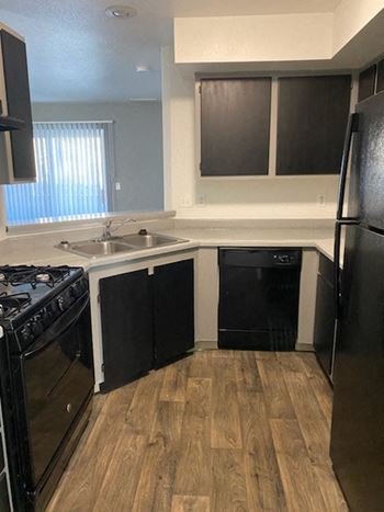a kitchen with a stove a sink and a refrigerator